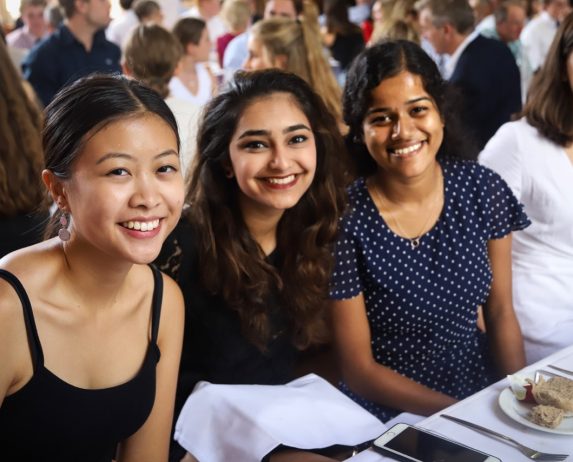 St Andrew’s College women sitting together at a formal dinner event in the College’s Dining Hall